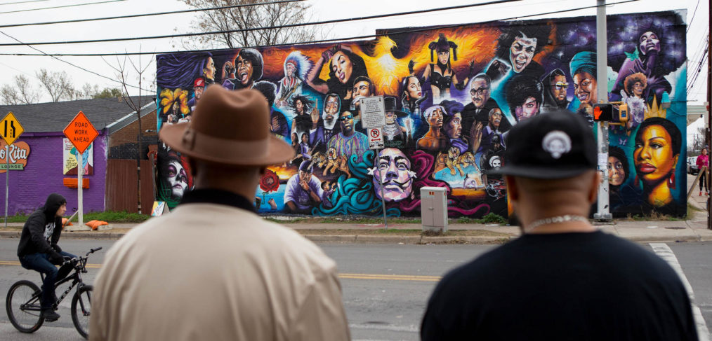 Two men in East Austin look at new mural on 12th & Chicon, Austin TX