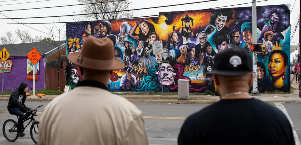 Two men in East Austin look at new mural on 12th & Chicon, Austin TX