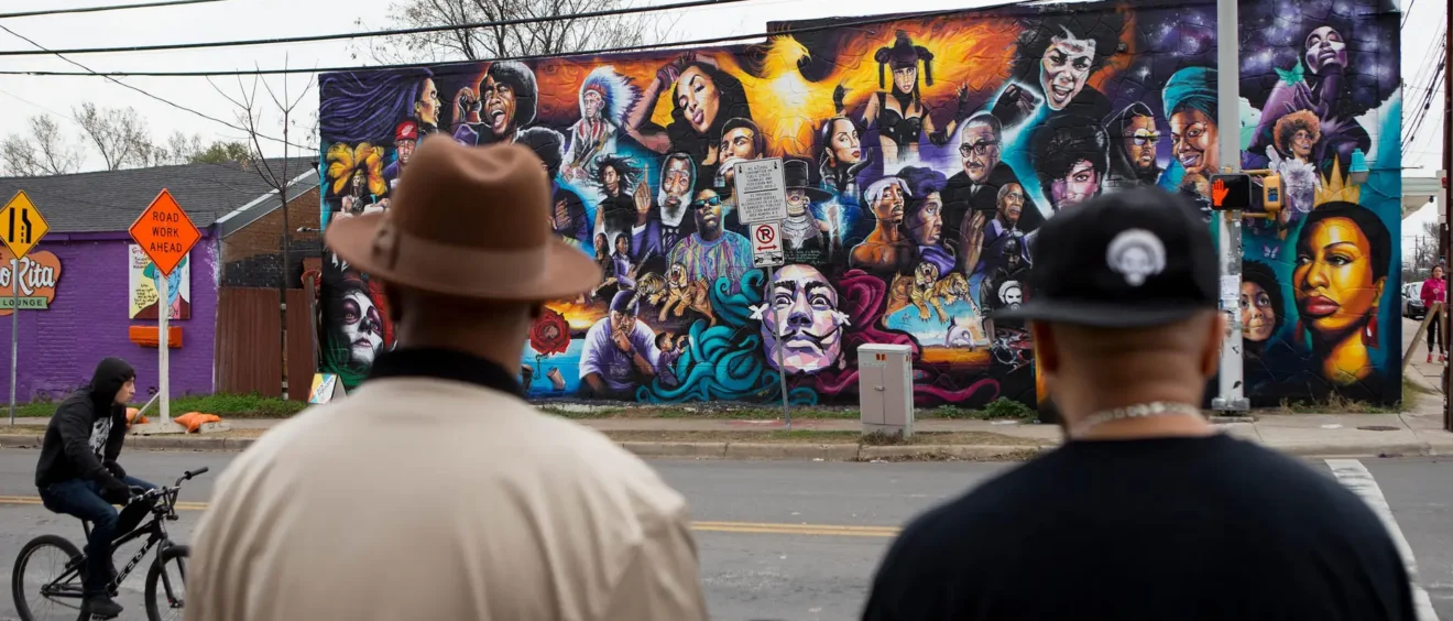 Two men in East Austin look at new mural on 12th & Chicon, Austin TX
