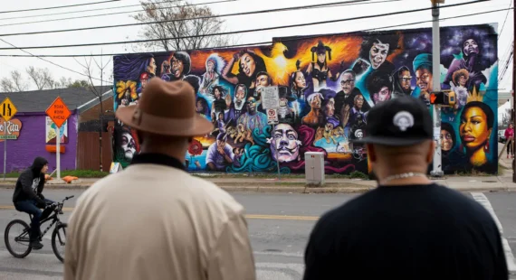 Two men in East Austin look at new mural on 12th & Chicon, Austin TX