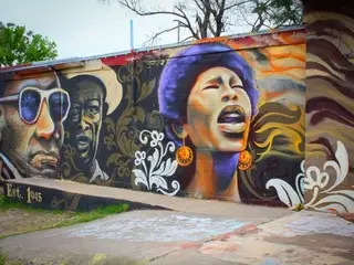 Landscape view of colorful mural on side of Victory Grill, featuring Lavelle White, Johnny Holmes, Roosevelt “Grey Ghost” Williams.
